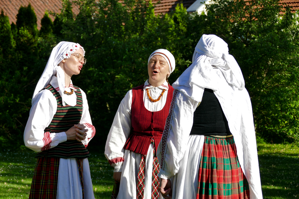 People in Lithuanian attire singing folk songs.