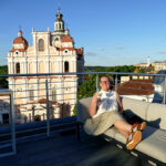 Renata Green in Vilnius on the roof top terrace of the Radisson Collection Astorija Hotel across from the iconic Church of St. Casimir.