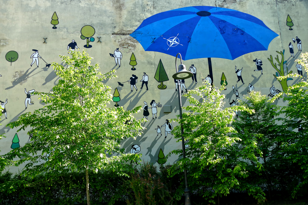 In January 2024, NATO unveiled a 15-meter-high street mural symbolizing security and protection in Vilnius, Lithuania. It was designed by Lithuanian street artist Žygimantas Amelynas.
