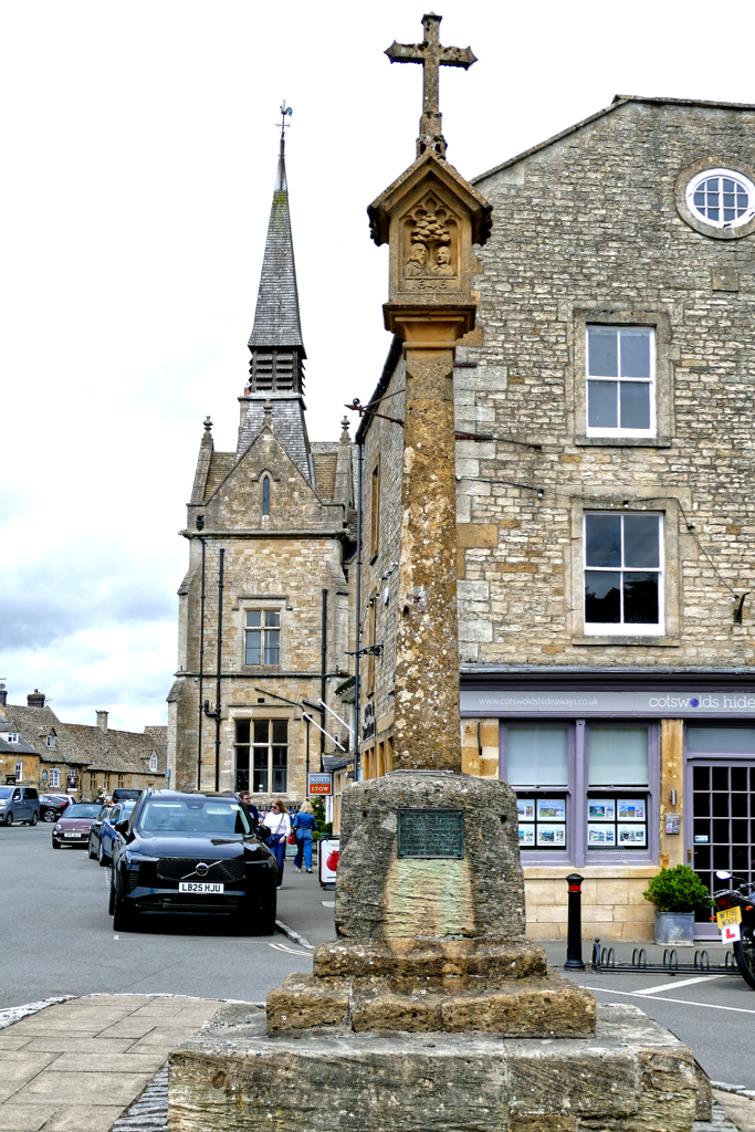 Stow-on-the-Wold's Market Cross with St. Edward’s Hall in the backdrop. 
