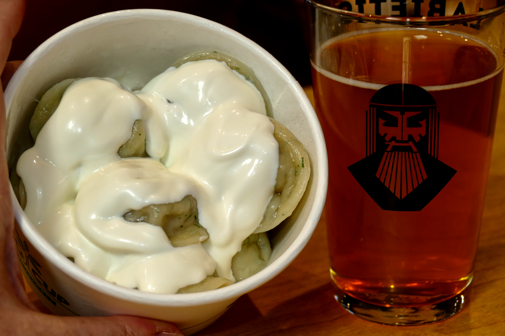 Pelmeni in a delicious sour cream sauce. Served with a freshly tapped craft beer.