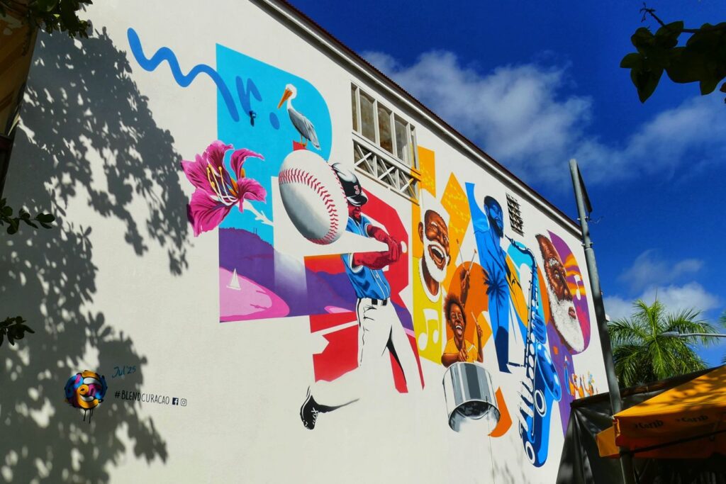 Curaçao‑based artist Sander van Beusekom, whom I've also introduced in my post Best Street Art in Curaçao, contributed this mural, honoring the local community icon Louis “Porkchop” Lambert Richardson.