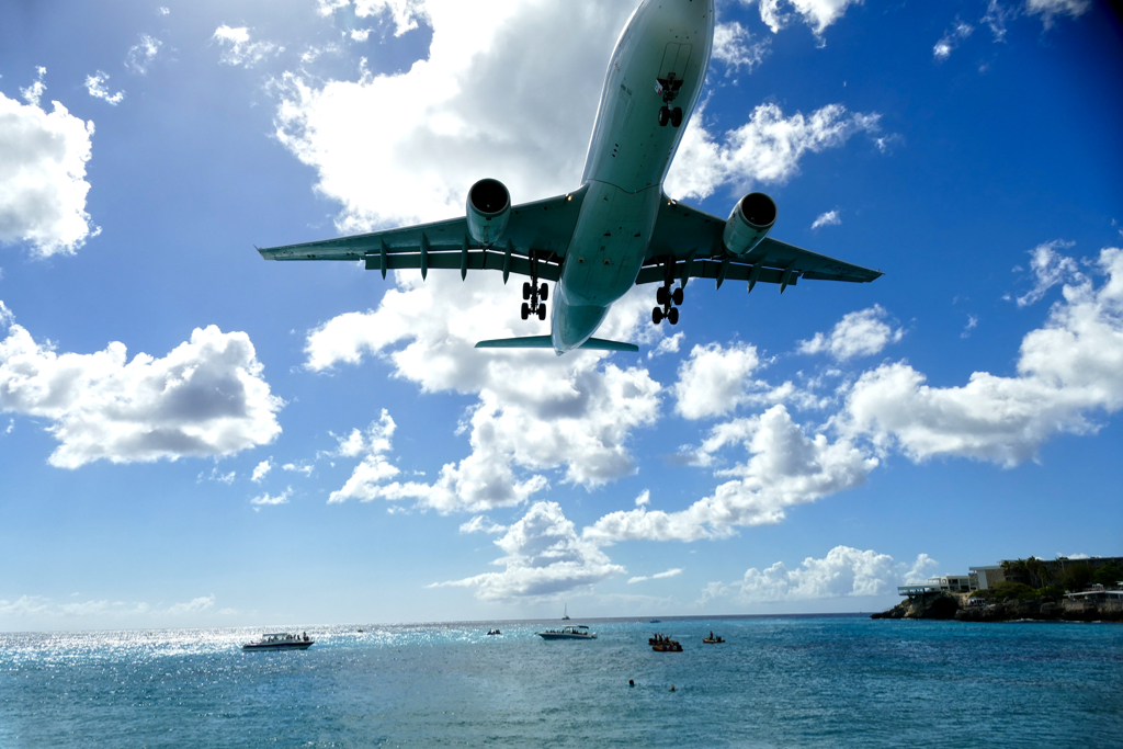 Plane flying over Maho Beach.