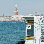 View of Venice with an ad for the Biennale di Arte 2026 in Venice.