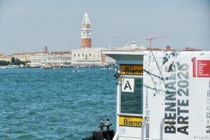 View of Venice with an ad for the Biennale di Arte 2026 in Venice.