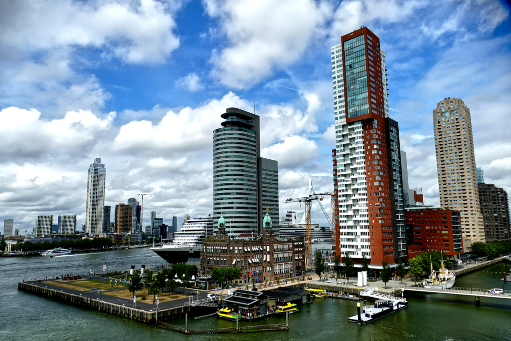 The icons of Wilhelminaplein from left to right: the round building of the World Port Center, designed by Sir Norman Foster, the Montevideo Residential Tower by Mecanoo, and the New Orleans Apartment Building by Álvaro Siza. In the foreground, the legendary Hotel New York.