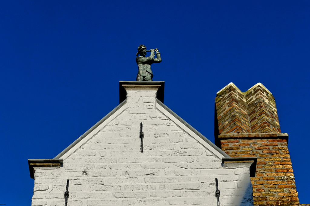 Rooftop sculpture in Bruges.