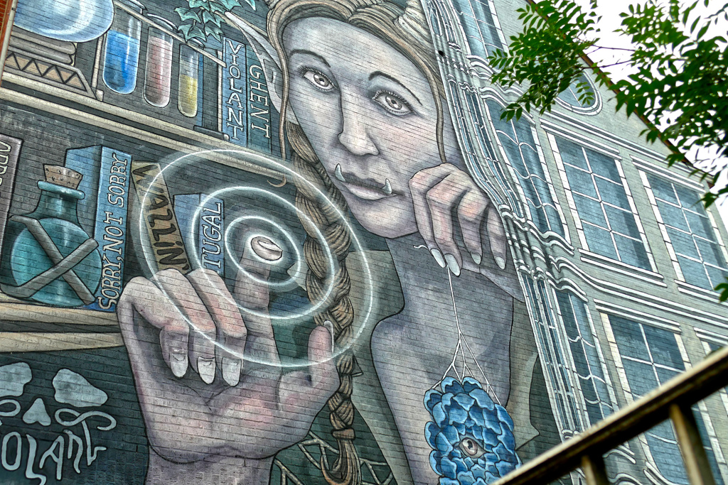 "Abracadabra" mural painted on a brick building by VIOLANT aka JoĆ£o MaurĆcio