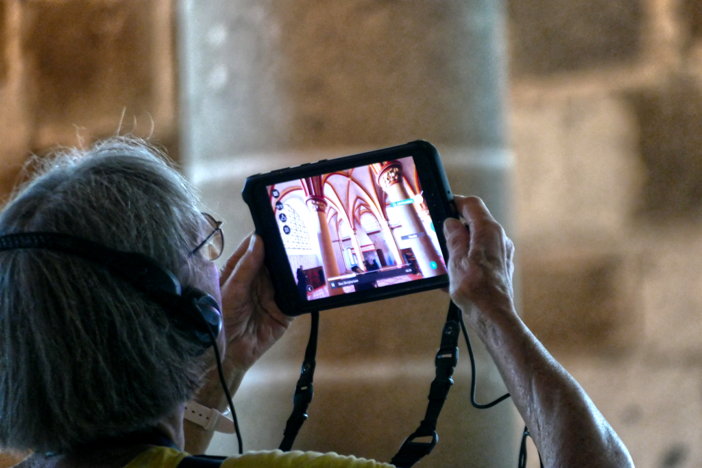 Woman looking a tablet at Mont-Saint-Michel.