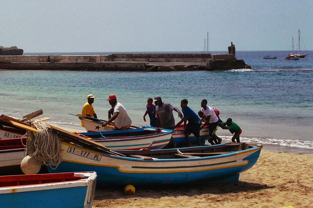 Fishermen pulling boat on shore in Tarrafal, Cape Verde