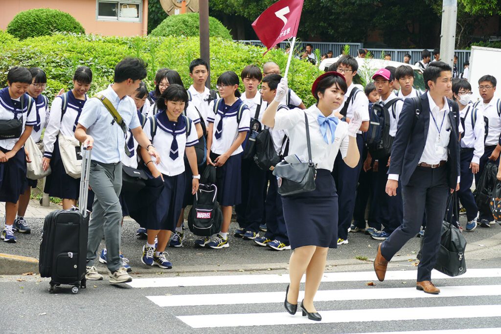 School Class crossing street in Japan, showing how to behave.