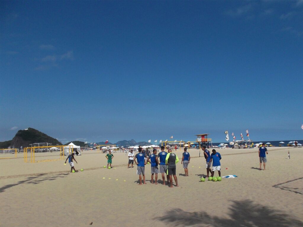 Rough guys playing soccer on the beach in Rio de Janeiro