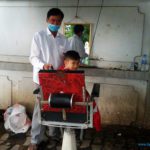 Boy getting a haircut in Phnom Penh, Cambodia