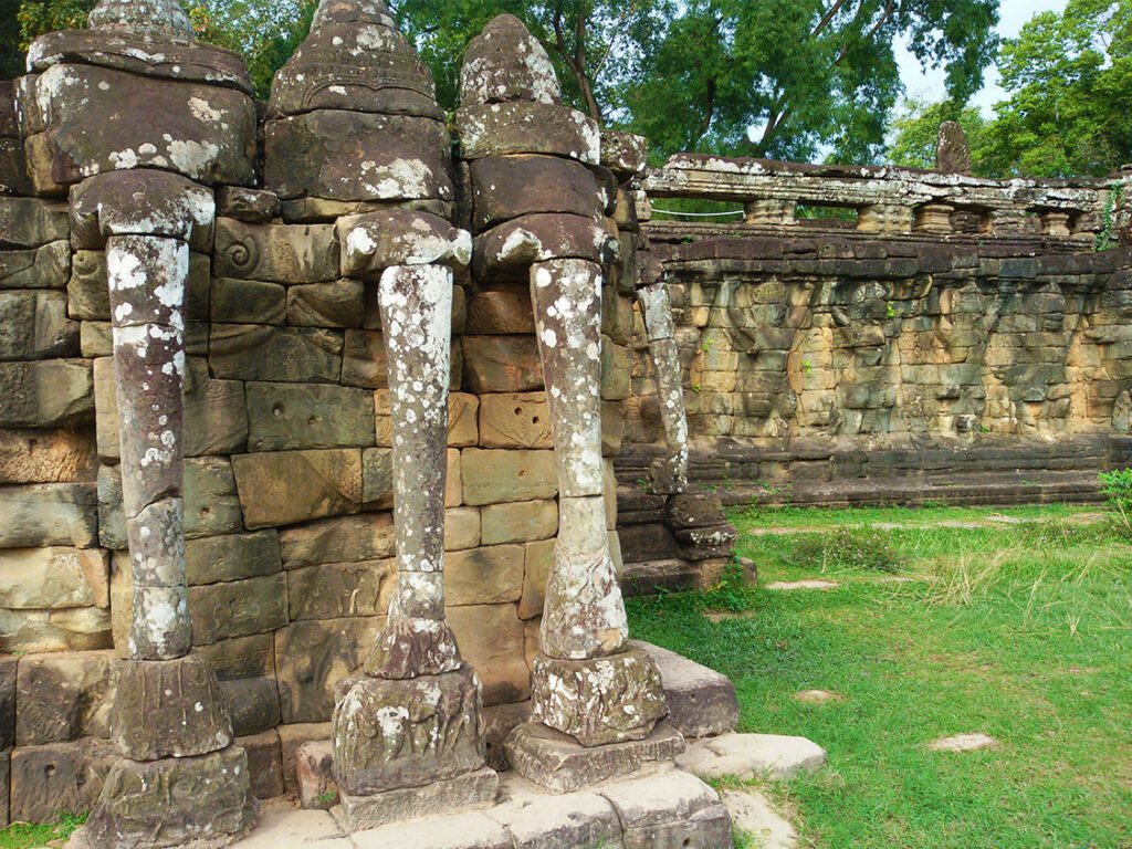 Besides the fanciful carvings of the elephants, there are also these stylized heads and trunks. In the background, you can see the garudas making an effort to hold the balustrade up.