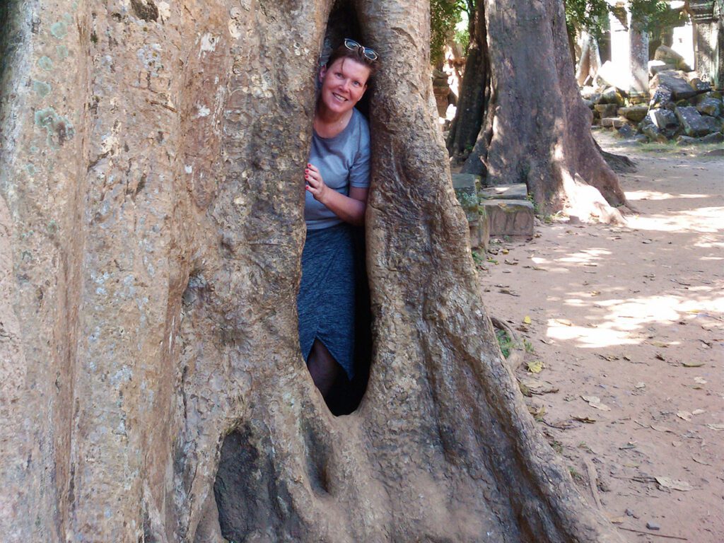 Renata Green hiding in a tree at Angkor Wat 