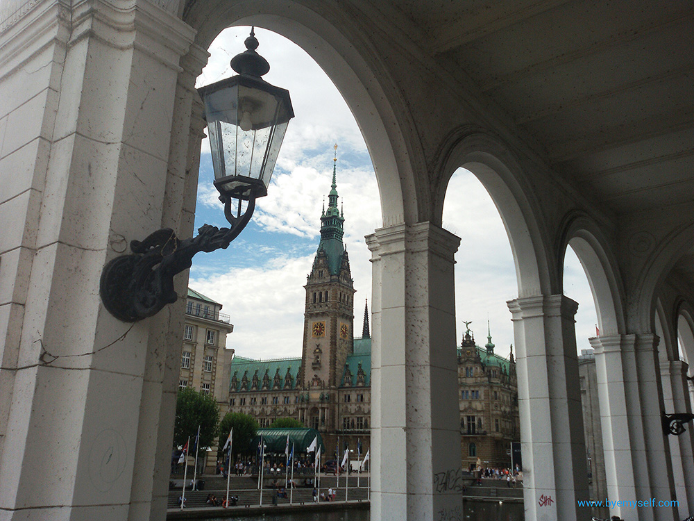 Hamburg town hall, seen from the adjacent Alsterarkaden, the Alster arcades, housing posh cafés, and specialty shops.