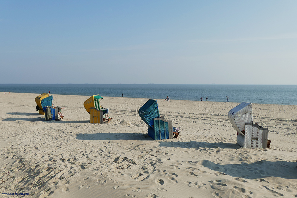 Hooded wicker chairs on the beach of Foehr